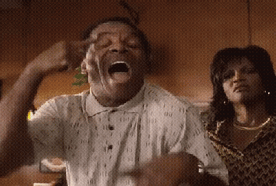 Man Making Funny Face With Woman Behind Him GIF