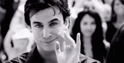 Man Making Peace Sign in Crowd