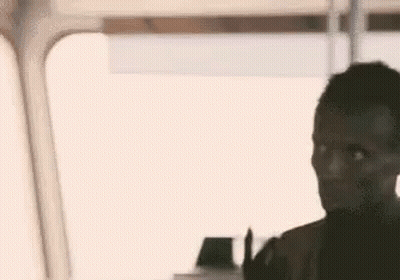 Man Making Peace Sign Sitting On Train GIF