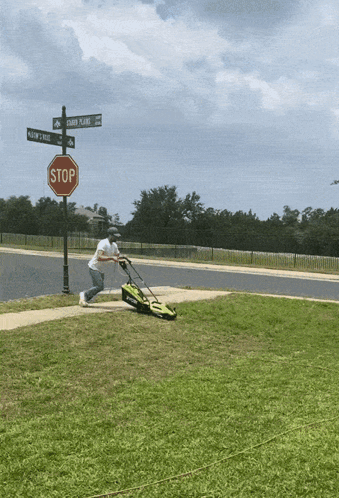Man Mowing Green Lawn Near Stop Sign GIF