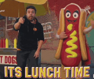 Man Next To Hot Dog Mascot Saying Its Lunch Time GIF