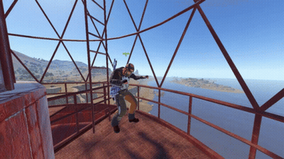 Man On Balcony Overlooking Water And Mountains GIF