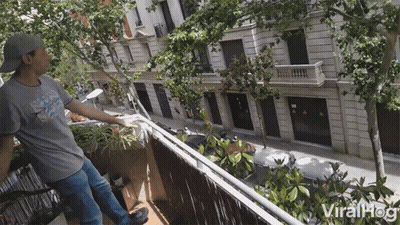 Man On Balcony With ViralHog Logo GIF