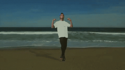 Man On Beach Arms Outstretched GIF