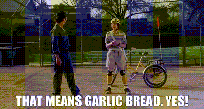 Man on Bicycle Talking to Man on Baseball Field