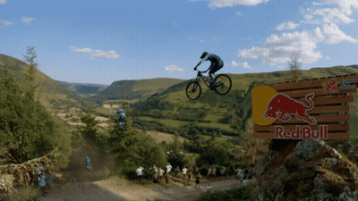 Man On Bike Jumping Over Red Bull Sign GIF