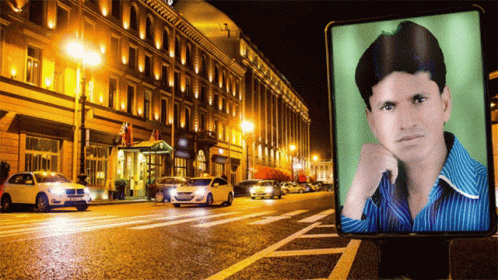 Man On Billboard In City At Night GIF