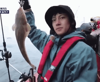 Man On Boat Holding Fish With Life Vest Saying Gill GIF