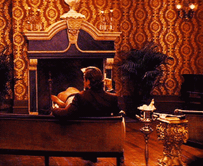 Man On Couch By Fireplace In Living Room GIF