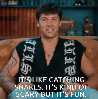 Man On Couch Saying It's Like Catching Snakes GIF