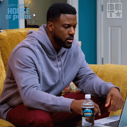 Man On Couch Using Laptop With Bottle Of Mountain Dew GIF