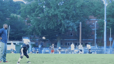 Man On Field With Sign Saying Load To The Max GIF
