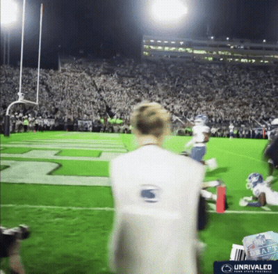 Man On Football Field Wearing Vest Saying Unrivaled GIF