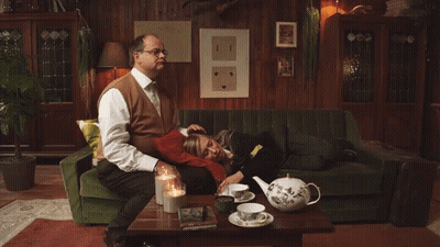 Man On Green Couch Woman On Lap GIF