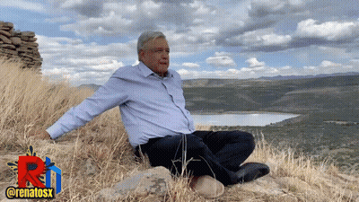 Man On Hill Arms Outstretched By Lake GIF