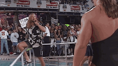 Man On Ladder In Front Of Crowd With Sign Saying 300A GIF