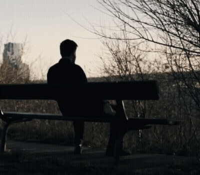 Man On Park Bench Overlooking City GIF