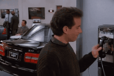 Man On Pay Phone Next To Car Saying Night GIF