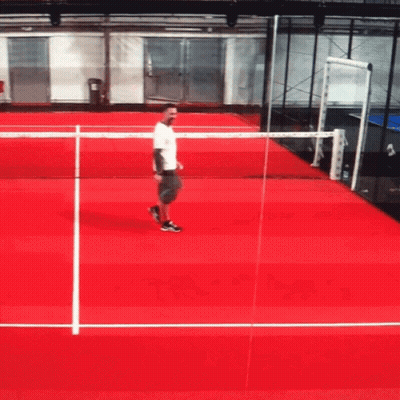 Man On Red Tennis Court Holding Racket GIF