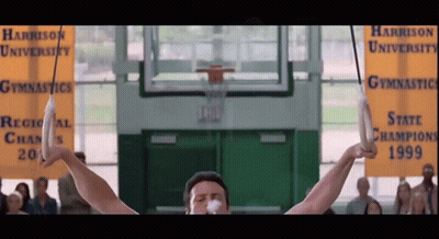 Man On Rings At Harrison University Gymnastics GIF