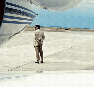 Man On Runway Looking At Plane GIF