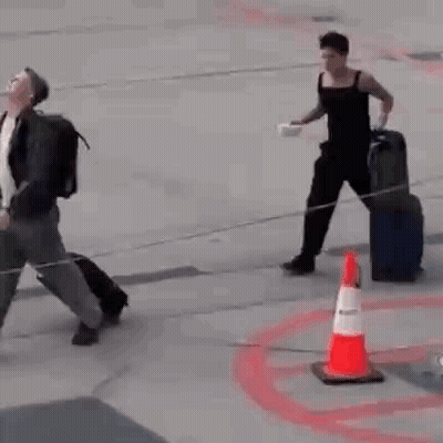 Man On Runway With Suitcase And Bowl GIF