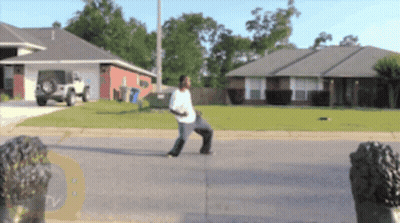 Man On Sidewalk In Front Of House With TV Logo GIF