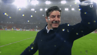 Man On Soccer Field With Arms In Air And BT Logo GIF