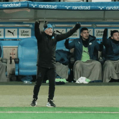 Man On Soccer Field With Arms In Air GIF