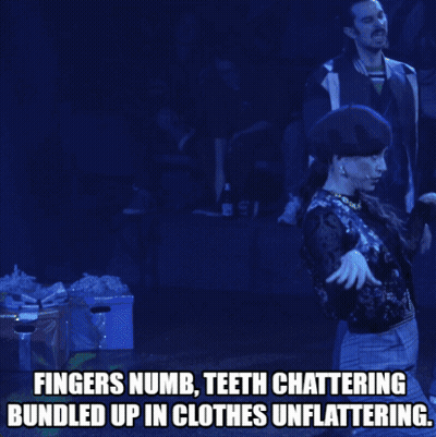 Man On Stage Fingers Numb Teeth Chattering Bundled Up In Clothes Unflattering GIF