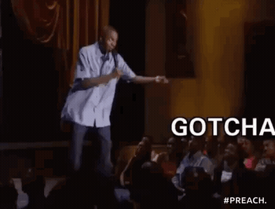 Man On Stage Holding Microphone Addressing Crowd GIF