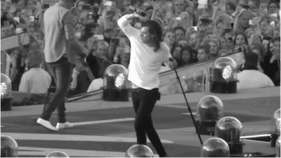 Man On Stage Holding Microphone GIF