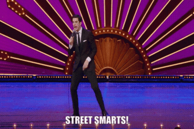 Man On Stage Holding Microphone With Street Smarts GIF