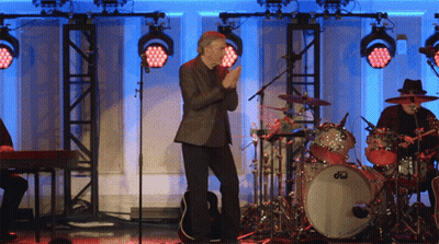 Man On Stage In Front Of Drum Set Saying DW GIF