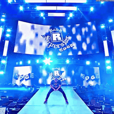 Man On Stage In Front Of Large R Logo GIF