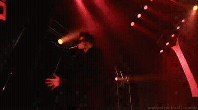 Man On Stage In Front Of Sign Saying M GIF