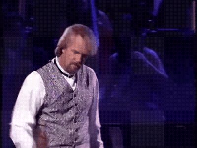 Man On Stage In Vest And Bow Tie GIF