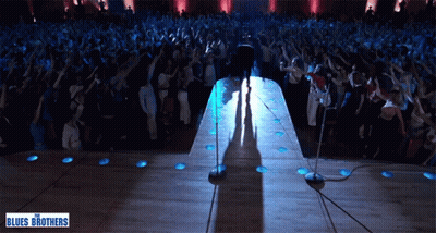 Man on Stage With Blues Brothers Sign