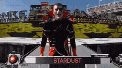 Man On Stage With Stardust Sign GIF