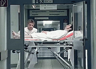 Man On Stretcher With Lynx Ambulance Sign GIF