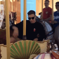 Man On The Carousel Blowing Kiss GIF