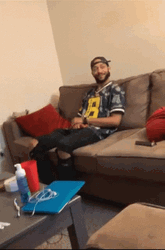 Man Oop Reaction While Seating On The Couch GIF