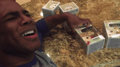 Man Opening Box Of Funko Pop Figures GIF