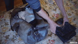 Man Packing Bags Quickly GIF