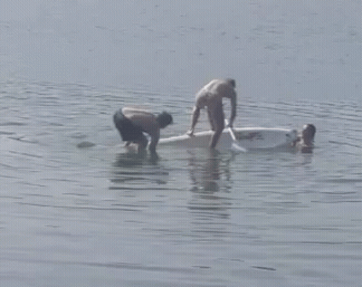 Man Paddling Boat While Another Watches GIF