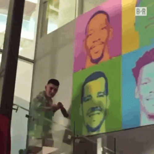 Man Painting Colorful Portrait On Wall GIF