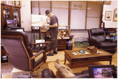Man Painting In Living Room With Hotel & Cafe Sign GIF