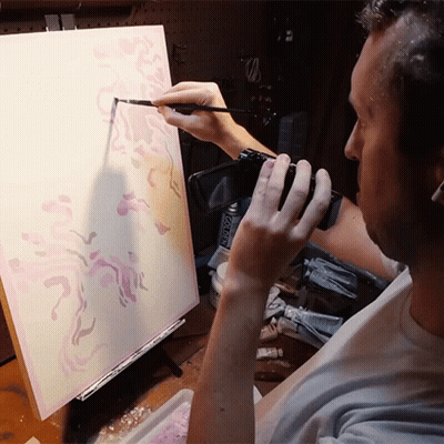 Man Painting On Canvas Holding Camera And Acrylic Paint GIF