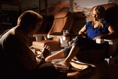 Man Painting Woman's Toenails In Chair GIF