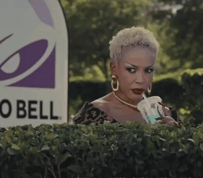 Man Peeking Behind Bush Near Taco Bell GIF